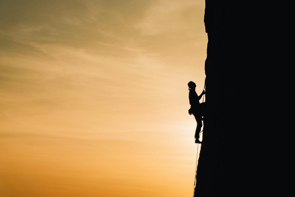 Man climbing a steep rock face