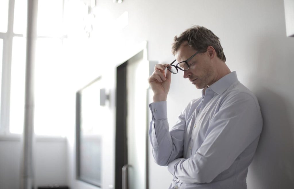 Alt=[stressed man against wall]-[povery happens when you do nothing]